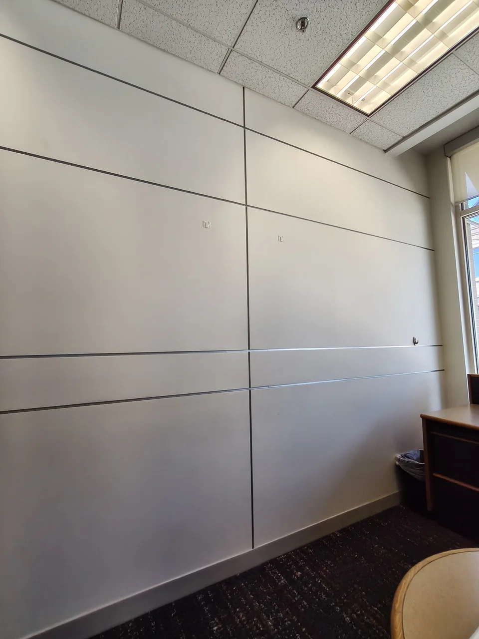 Light-colored wall panels with horizontal and vertical joints